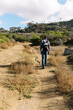 © Serena Burroughs/Stocksy - young father hiking in san diego california with son in baby carrier