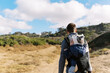 © Serena Burroughs/Stocksy - young father hiking in san diego california with son in baby carrier