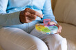 © Raymond Forbes LLC/Stocksy - Woman holding prescription pill organizer pharmaceutical