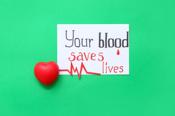 Wall Mural - Paper sheet with text YOUR BLOOD SAVES LIVES, heart and cardiogram on green background. World Blood Donor Day