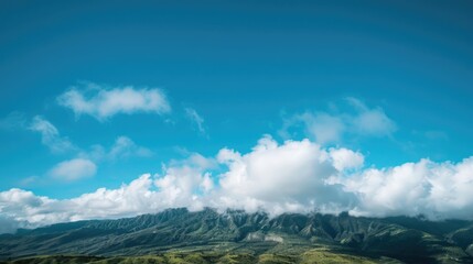 Wall Mural - mountain landscape below a clear azure sky with fluffy white clouds
