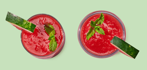 Wall Mural - Strawberry smoothie in cup on green pastel background