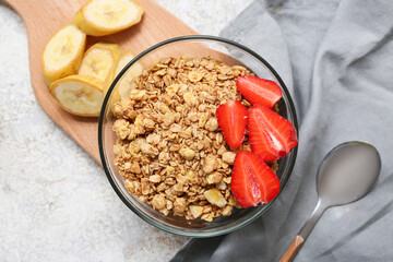 Wall Mural - Wooden cutting board, bowl with tasty granola, banana and berries on grunge background, closeup