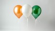 © Naret - Three colorful balloons - orange, white, and green - arranged together on a plain white background.
