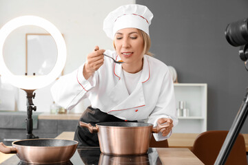 Sticker - Female food blogger cooking soup while recording video in kitchen