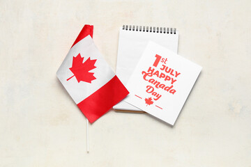 Wall Mural - Greeting card, Canadian flag and notebook on white background. Canada Day concept