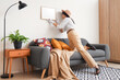 © Pixel-Shot - Female spy examining hanging frame on wall in room