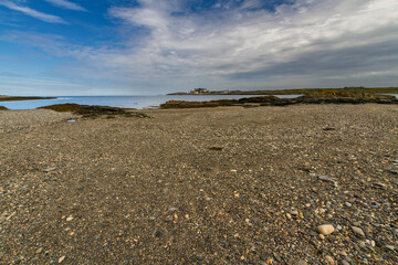 pebble beach pond and sea, blue sky.