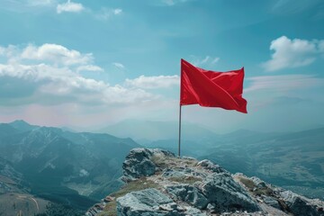 A red flag waving at the summit of a mountain