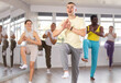 © JackF - Positive guy engaged in active dance together with other attendees of dancing courses