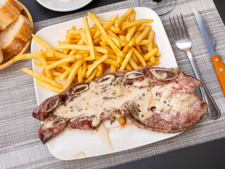 Sticker - Steak barbeque with pepper dished up with French fries with necessary table laying