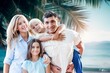 © BillionPhotos.com - happy young parents with children enjoying on a beach.