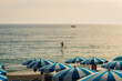 © Anna Tsukanova/Stocksy - Beach with blue umbrellas on Mediterranean coast