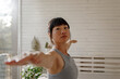 © Jovo Jovanovic/Stocksy - Flexible woman practicing yoga at home