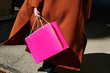 © Irina Bo/Stocksy - Elegant shopper carrying bright pink bag