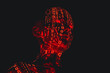 © Marcos Osorio/Stocksy - A humanoid illuminated by red light of zeros and ones