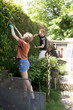 © Marisa Magnusen/Stocksy - Family yard work
