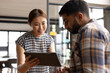 © Wavebreak Media - Asian businesswoman showing tablet to Asian male colleague in office