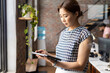 © Wavebreak Media - Asian woman in office holding tablet, looking focused and professional