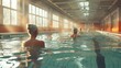 © Алина Бузунова - elderly women doing exercise in indoor swimming pool.