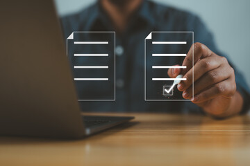 Poster - Businessman using electronic pen to tick correct sign mark in online document checklist for quality control assurance of ISO concept.