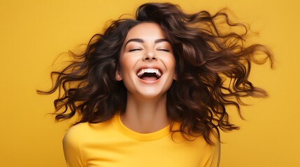 Canvas Print - A young woman with long, curly brown hair is smiling with her eyes closed. 