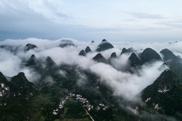 Wall Mural - Idyllic landscape of mountain village shrouded in mist