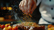 © Curioposs - Taste Extravaganza, Expert Chef's Hand Adds Flavor with Sprinkling Seasoning on Steak
