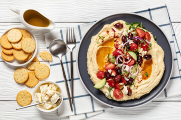 Wall Mural - Greek hummus with veggies, olives, feta on plate