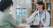 © peopleimages.com - Healthcare, tablet or girl and doctor with handshake in office for surgery, agreement or support. Hospital, service and client shaking hands with surgeon for digital plan, approval or treatment trust
