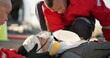 © CineLens/peopleimages.com - Paramedic, oxygen and outdoor with patient, helping and rescue of breathing, service or ambulance for person. EMS, accident or injury on street, healthcare and medical professional with victim in USA