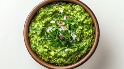 Guacamole close-up from above, rich green texture with herbs and onions mixed, served in a traditional bowl, isolated on a plain white background
