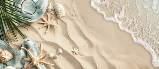 What you see from above: sandy beach adorned with a towel border, summer essentials, and sand texture with room for text.