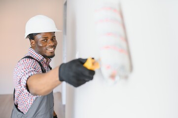 Wall Mural - African-American painter doing repair in room