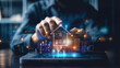 © Atchariya63 - A person's hand hovers over a glowing digital house icon on a laptop screen. The image represents home automation, technology, and smart home concepts.