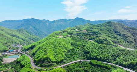 Wall Mural - Aerial view of curvy highway road and green mountain nature landscape in Ningbo, Zhejiang Province, China. Asphalt road on top of mountain.
