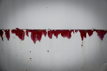 Wall Mural - A wall with red paint dripping down 