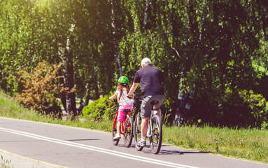 Wall Mural - Cyclists ride on the bike path in the city Park
