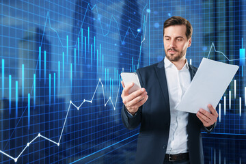 Canvas Print - Attractive young businessman with paperwork, smartphone and growing blue forex chart on blurry city background. Financial success and market concept. Double exposure.