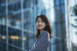 © song - Smiling Asian Office Lady in Office Building Background