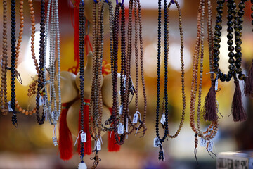 Poster - Religious souvenir shop. Buddhist  prayer beads and bracelets.