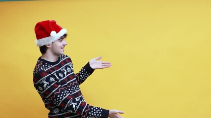 Wall Mural - young man or student with santa claus hat isolated on background