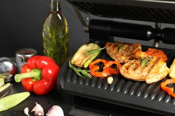 Wall Mural - Electric grill with different products on grey table