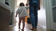 © maxximmm - baby first steps with dad. happy family a kid dream concept. dad and baby daughter walk along the corridor of the house indoors. dad and daughter care, hold hands, walk, take lifestyle first steps