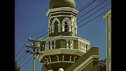 Wall Mural - CAPE TOWN, South Africa - CIRCA 1980: colorful Bo-kaap muslim quarter. Green mosque with minaret Masjid Boorhaanol Islam. Historical archival footage in Cape Town city of 1980 South Africa.