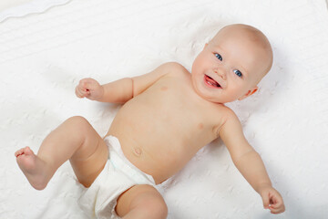 Wall Mural - Little baby on white bed