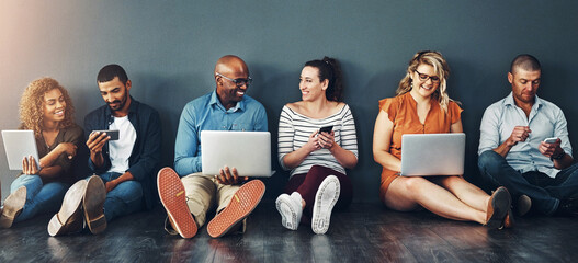 Leinwandbilder - Technology, people and collaboration sitting on floor for teamwork, communication and diversity in office. Group, men and woman online for social media post, internet browsing or company research