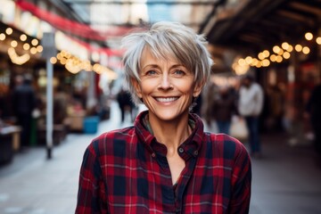 Portrait of a joyful woman in her 50s dressed in a relaxed flannel shirt over vibrant market street background