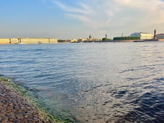 city river view, river in the city center, blue sky, white clouds, summer