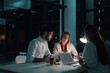 © Reese Coop/peopleimages.com - Teamwork, people and laptop in office at night with documents for deadline or overtime as accountant. Employee, partner and information for financial reviews, records and auditing in business report
